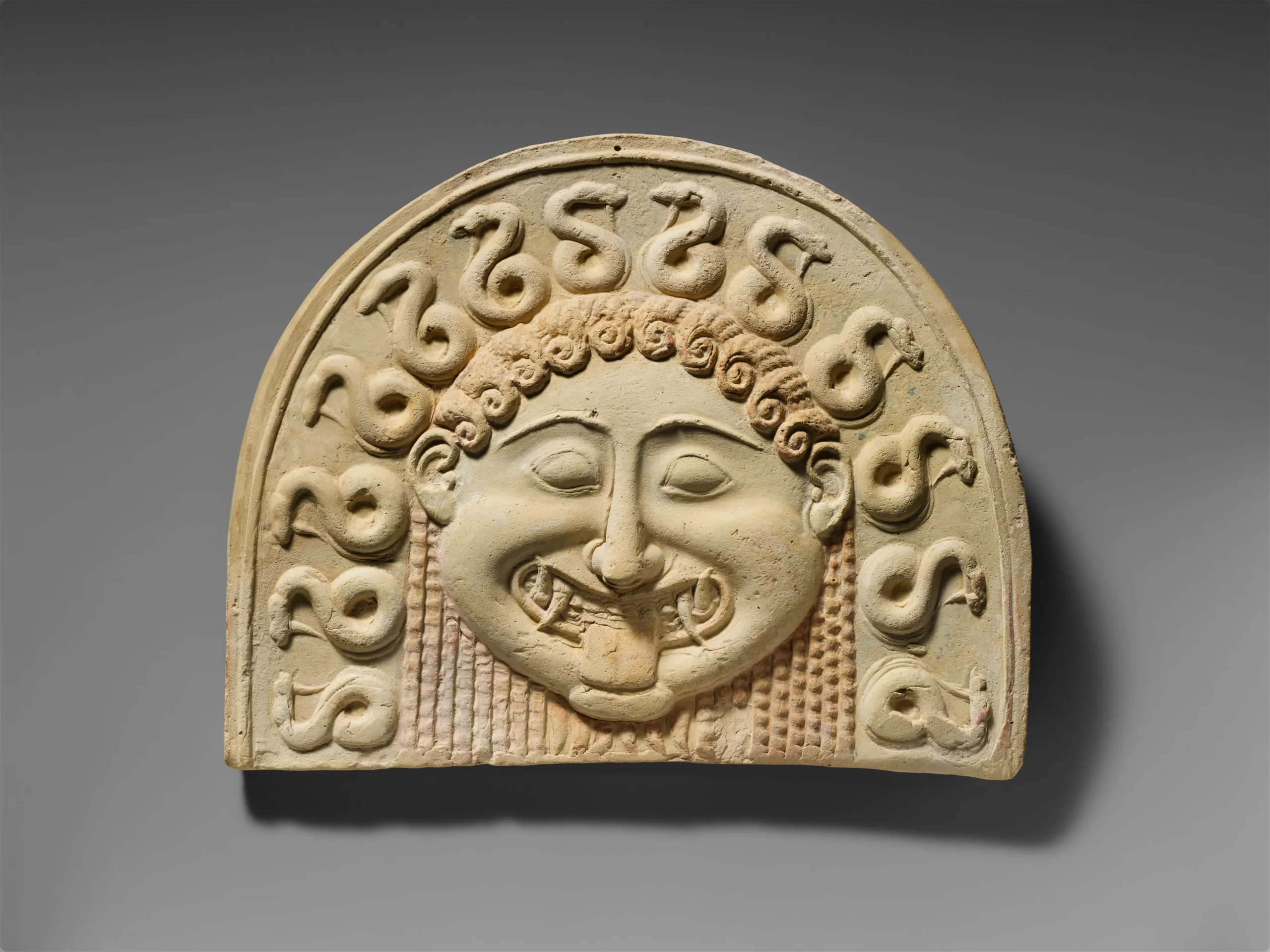 Terracotta painted gorgoneion antefix (roof tile)ca. 540 BCE